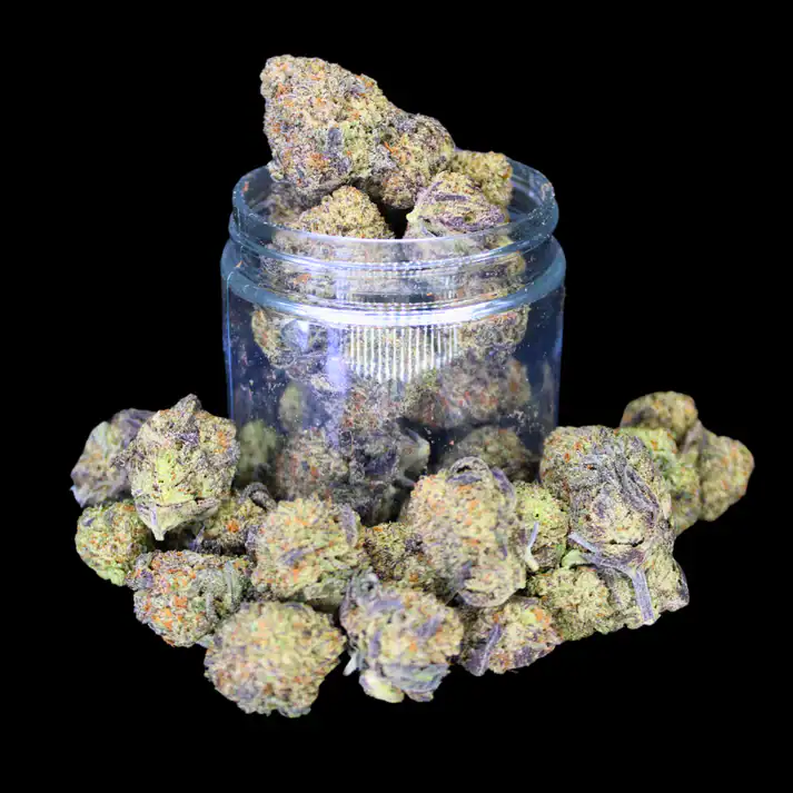 High-quality cannabis buds in a glass jar, surrounded by loose buds on a black background.